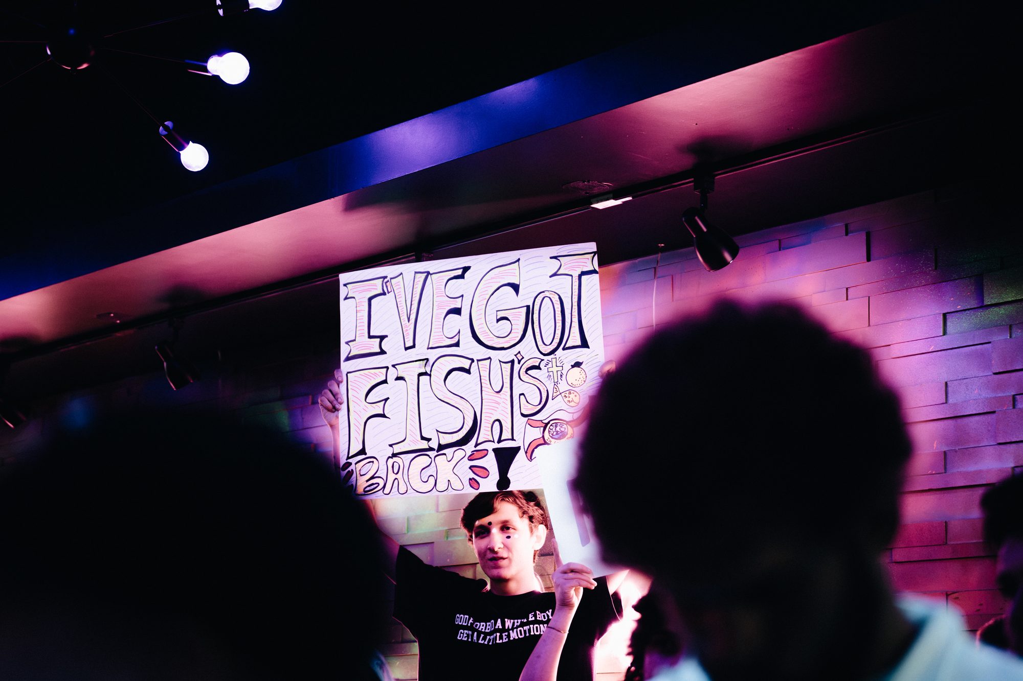 Supporter holding a handmade sign above the crowd