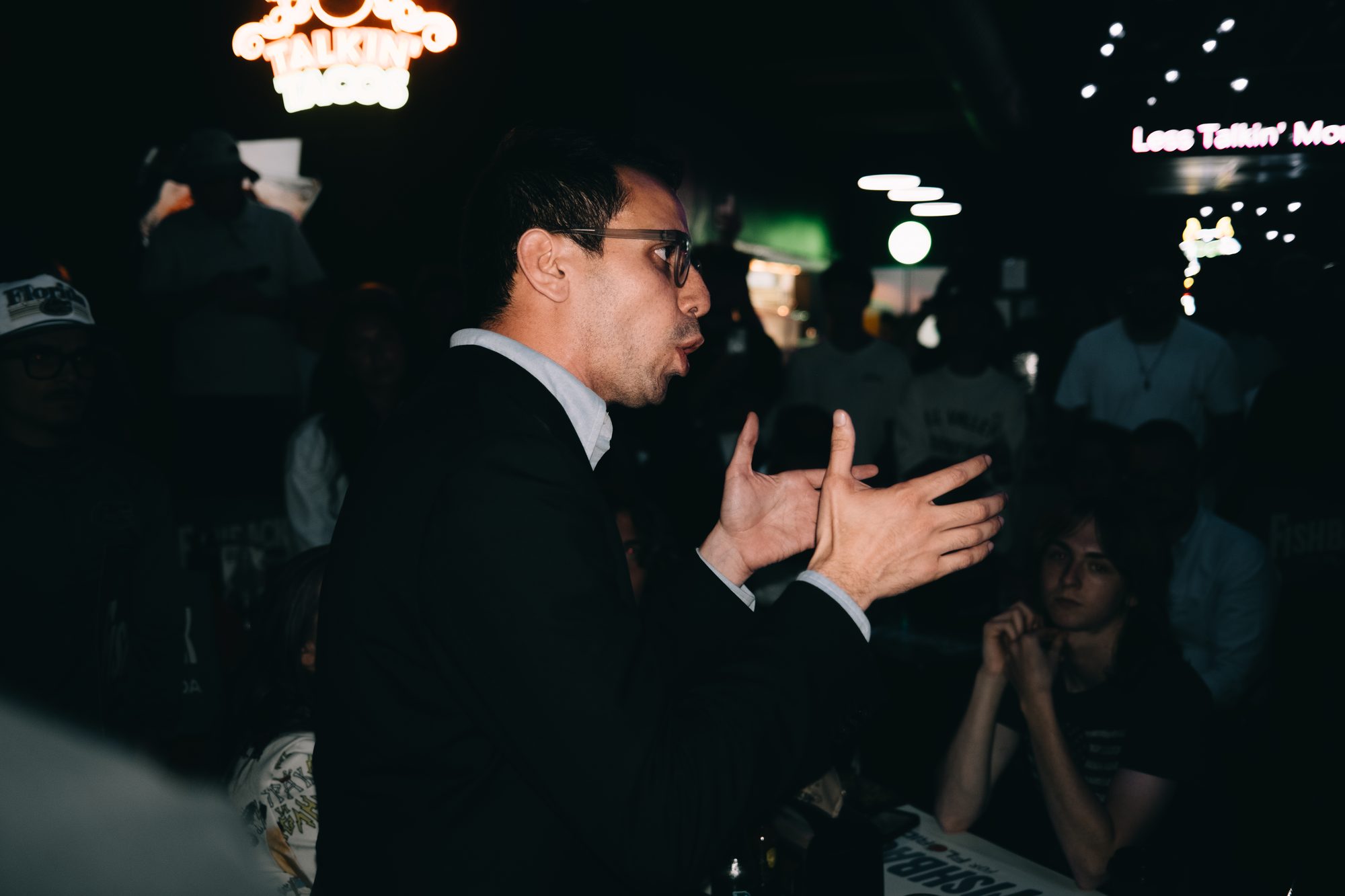 Candidate gesturing while he talks with a small group
