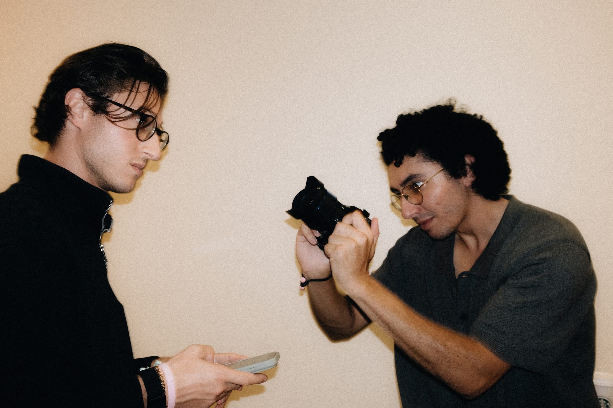 Crew member checking a camera in a hotel hallway