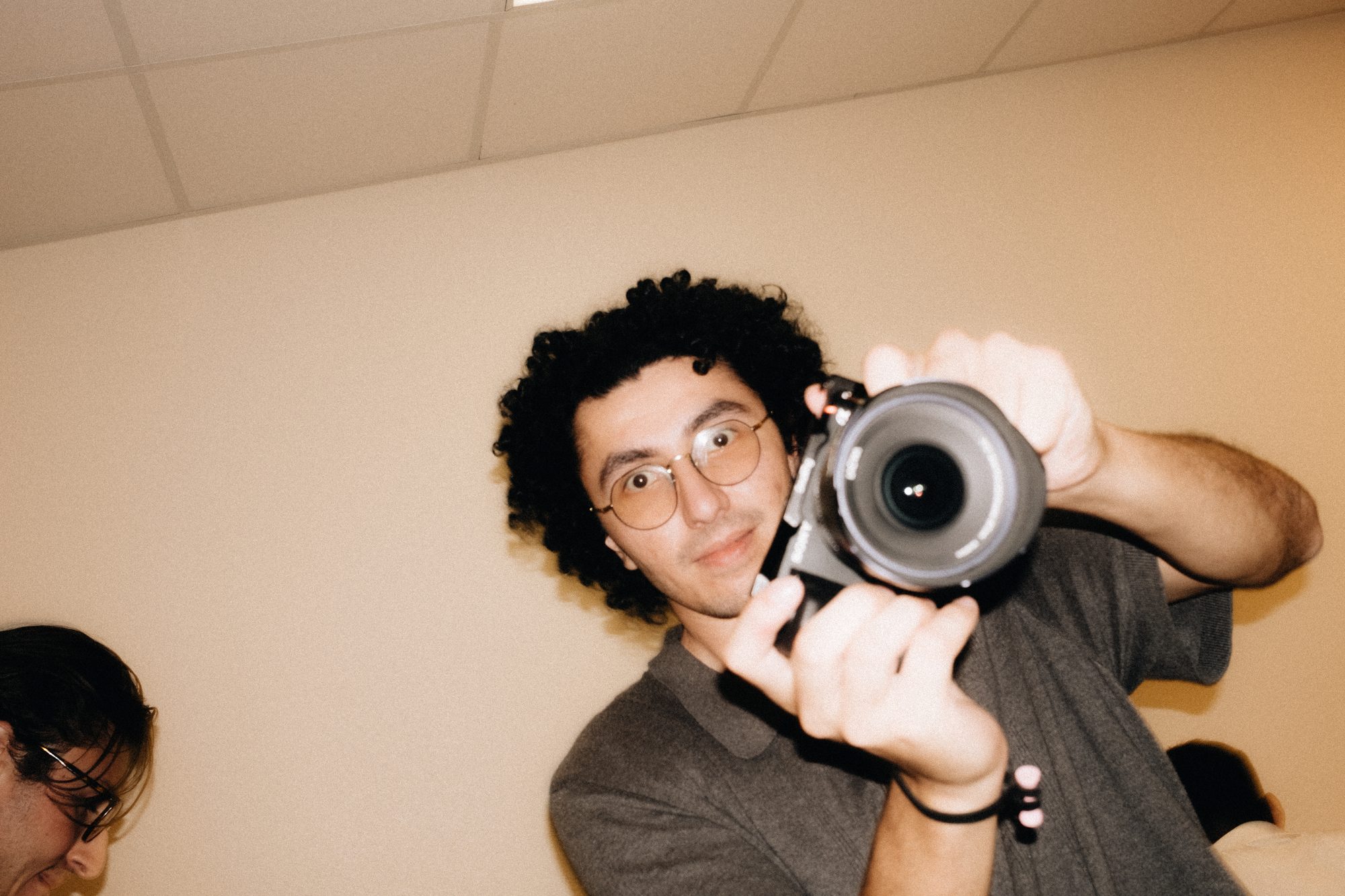 Shooter pointing a camera at the lens