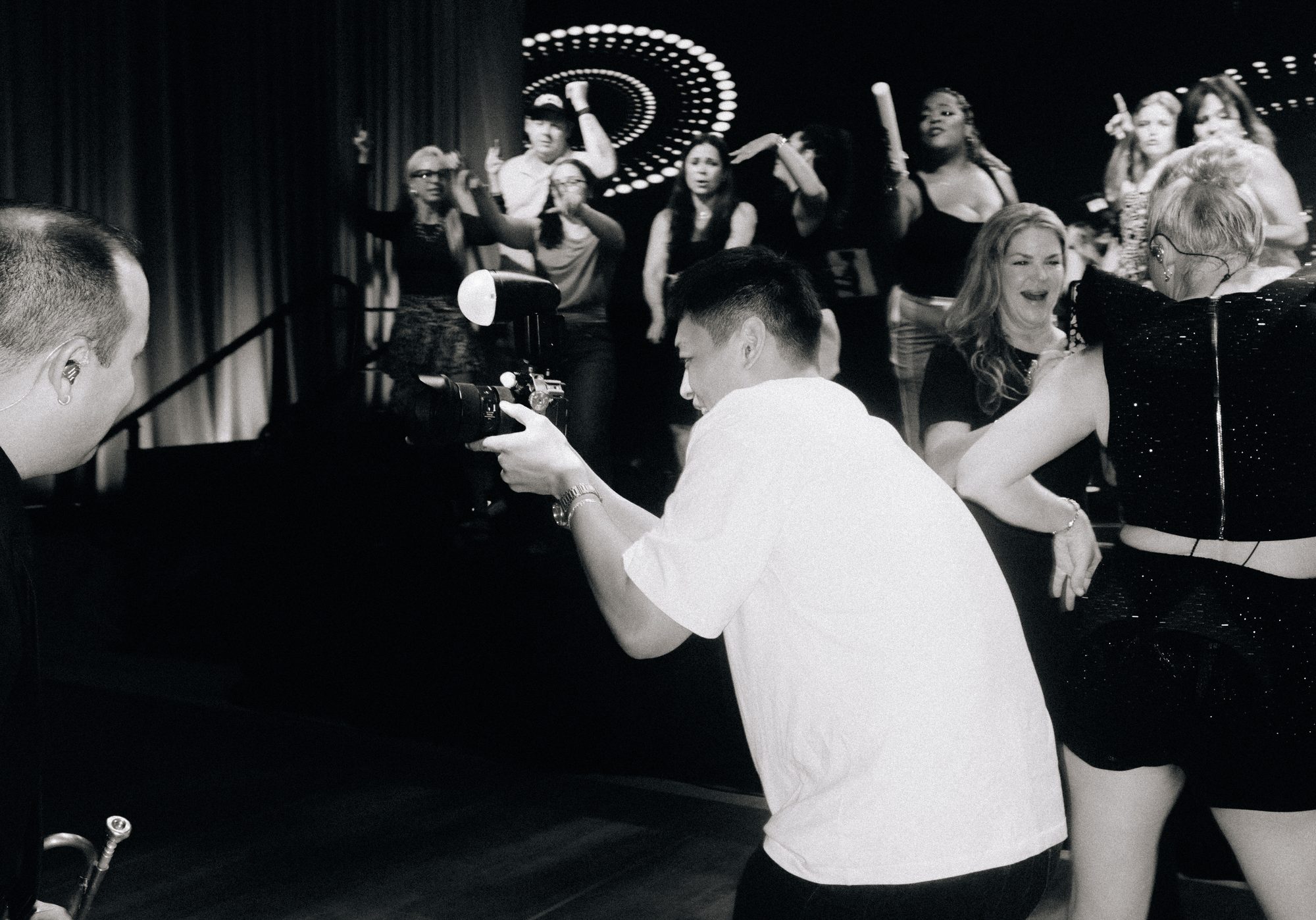 Shooter on a packed dance floor, black and white