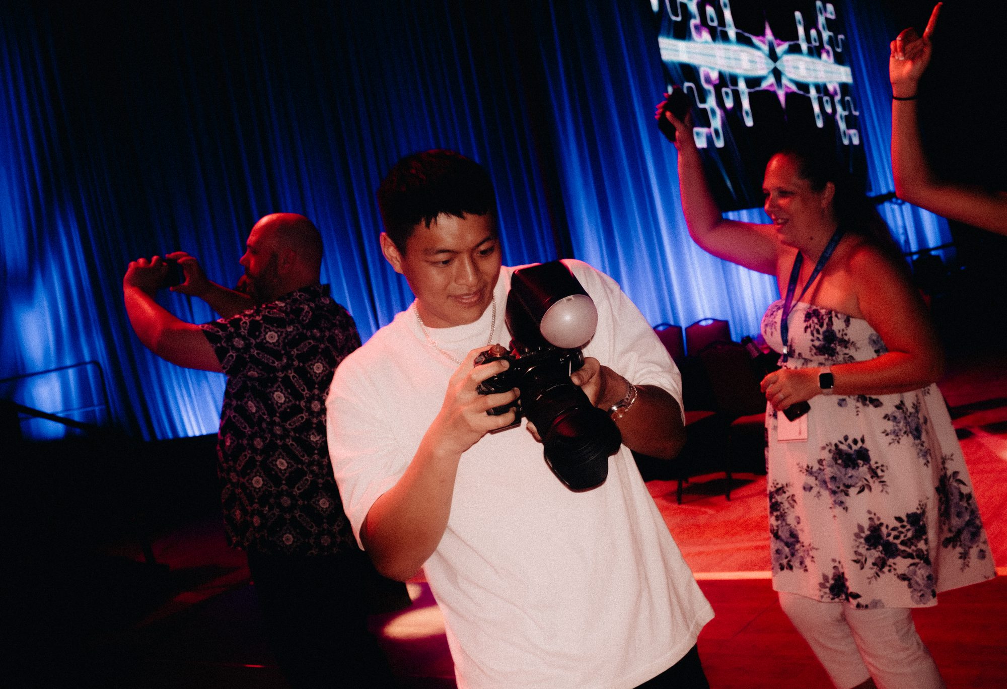 Shooter filming the dance floor under red light