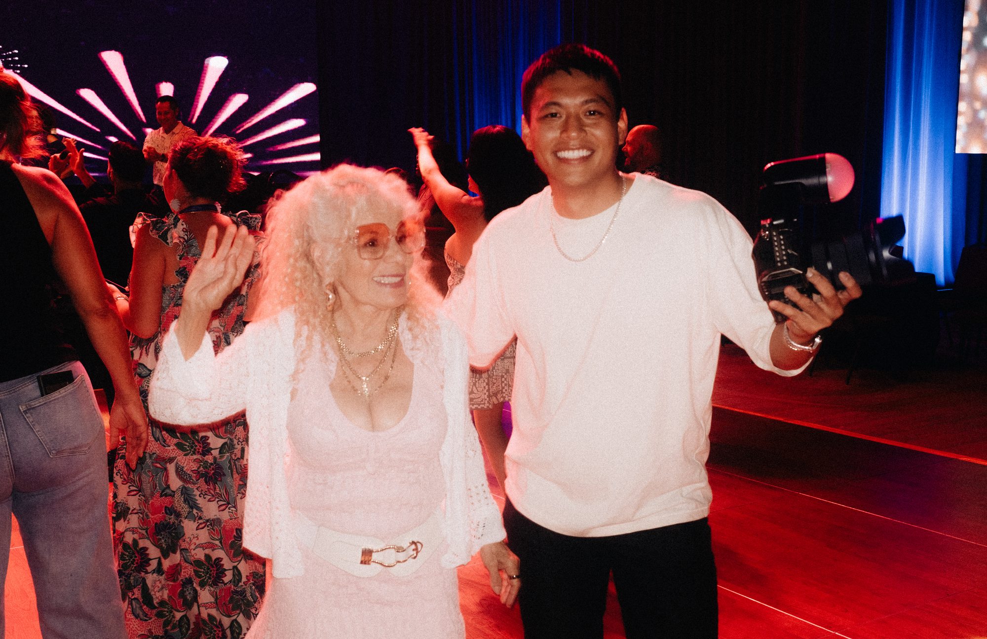 Guest dancing next to a shooter holding a camera