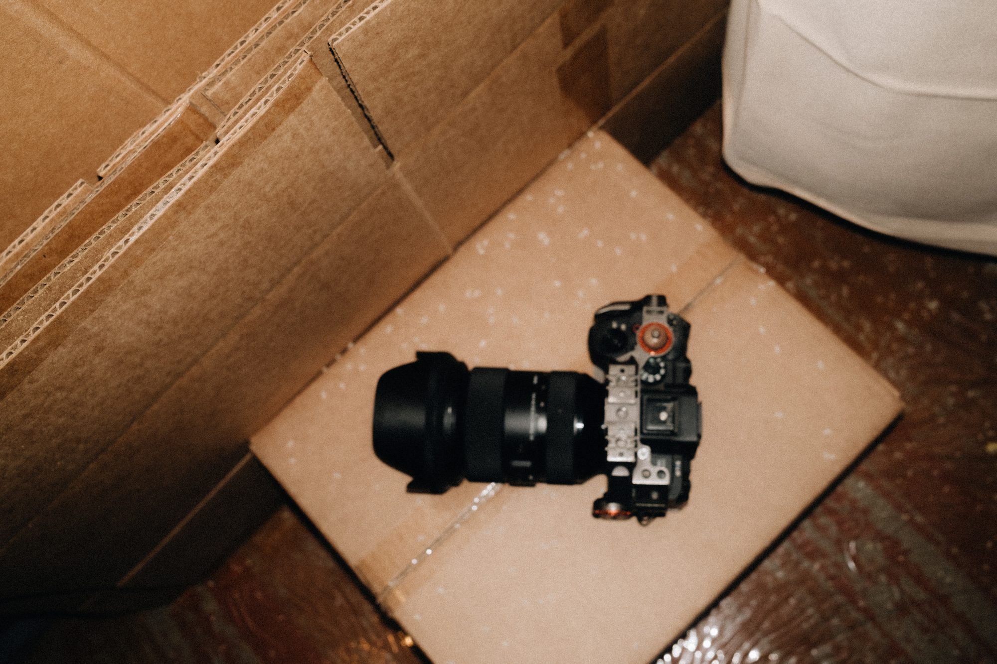 Camera and lens laid on an open box
