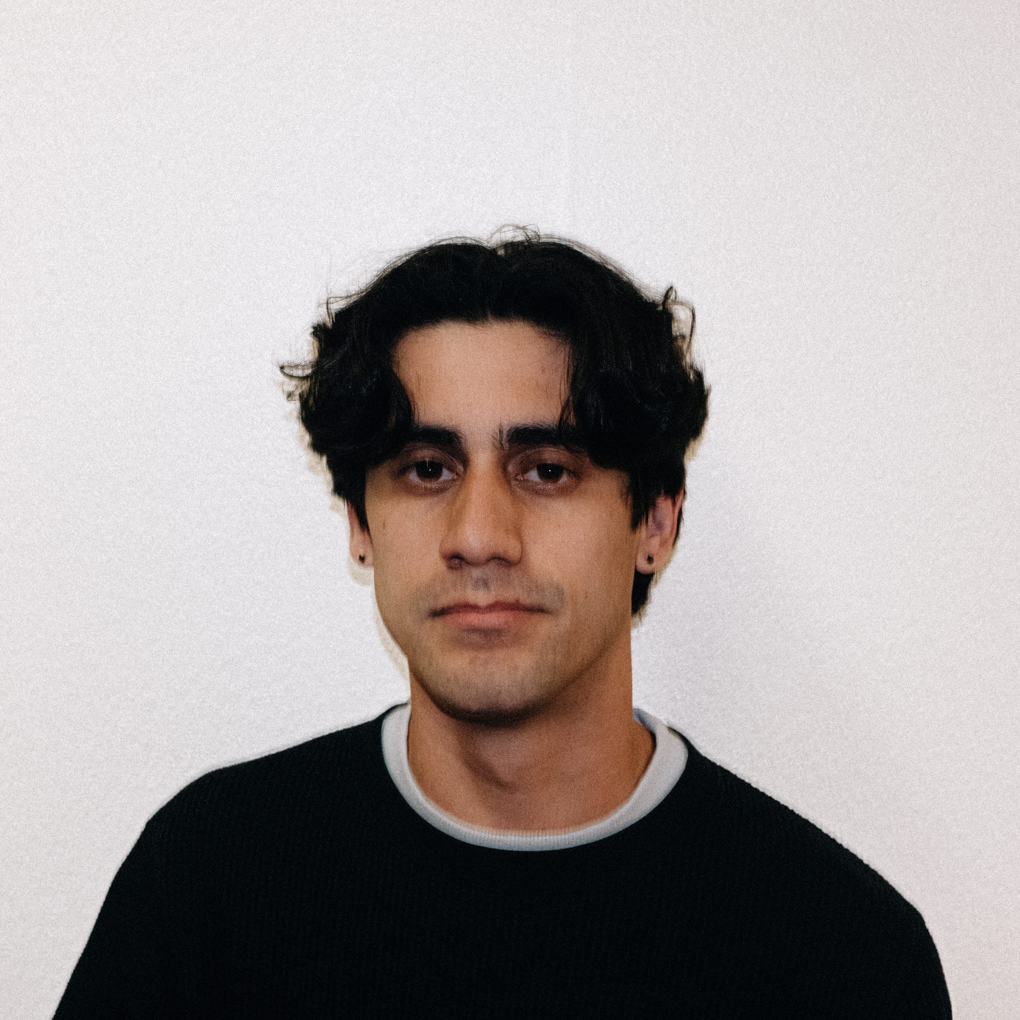 Portrait of a crew member against a white wall