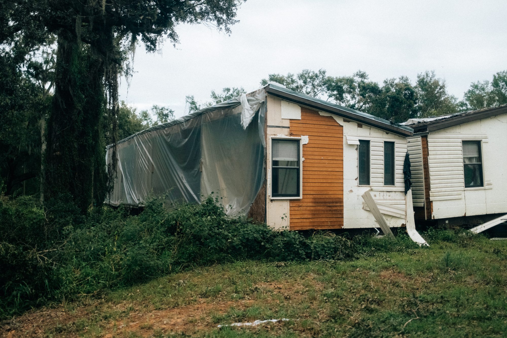 House split open with its siding peeled away