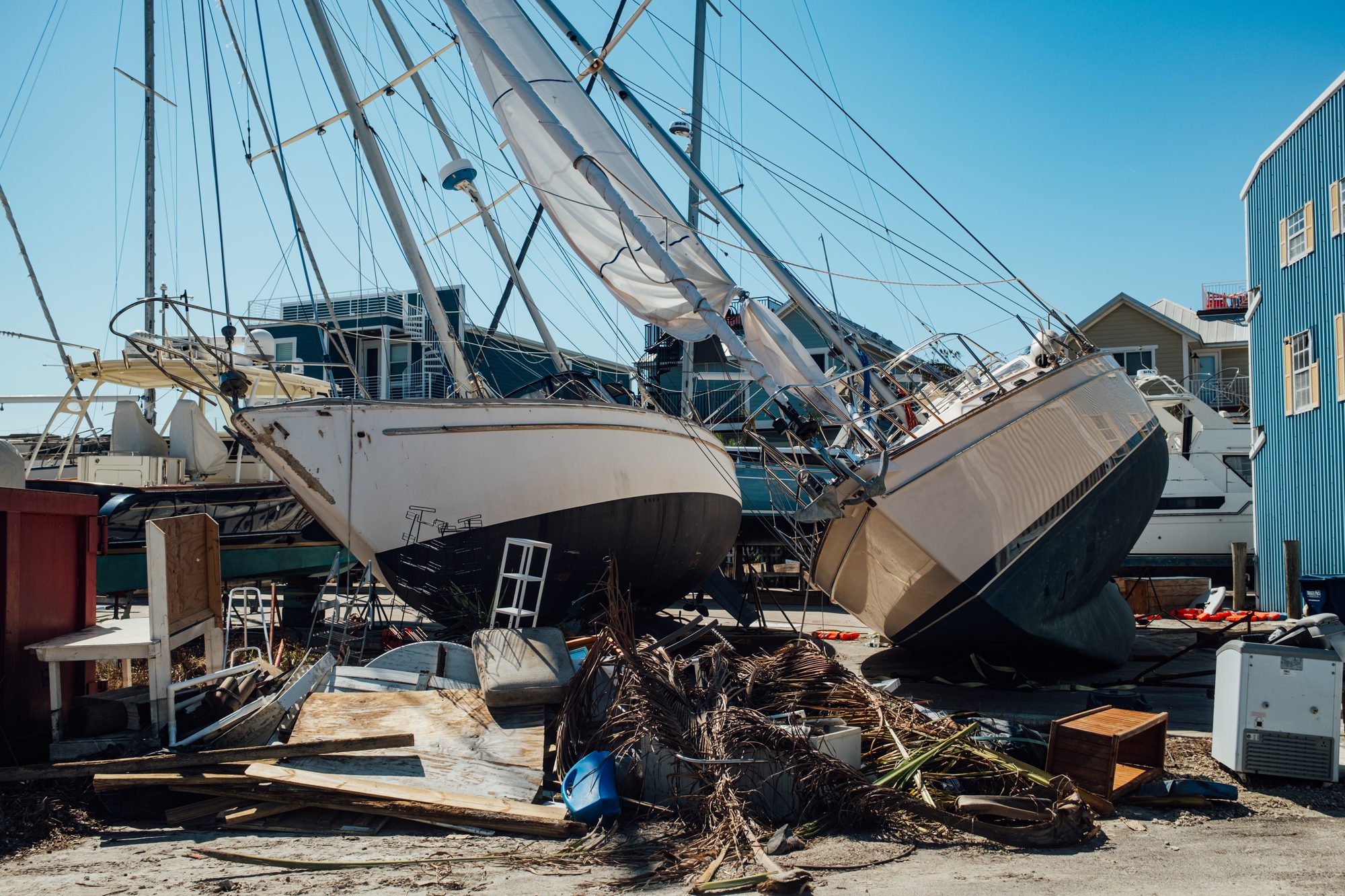 Sailboats piled on top of each other in a street