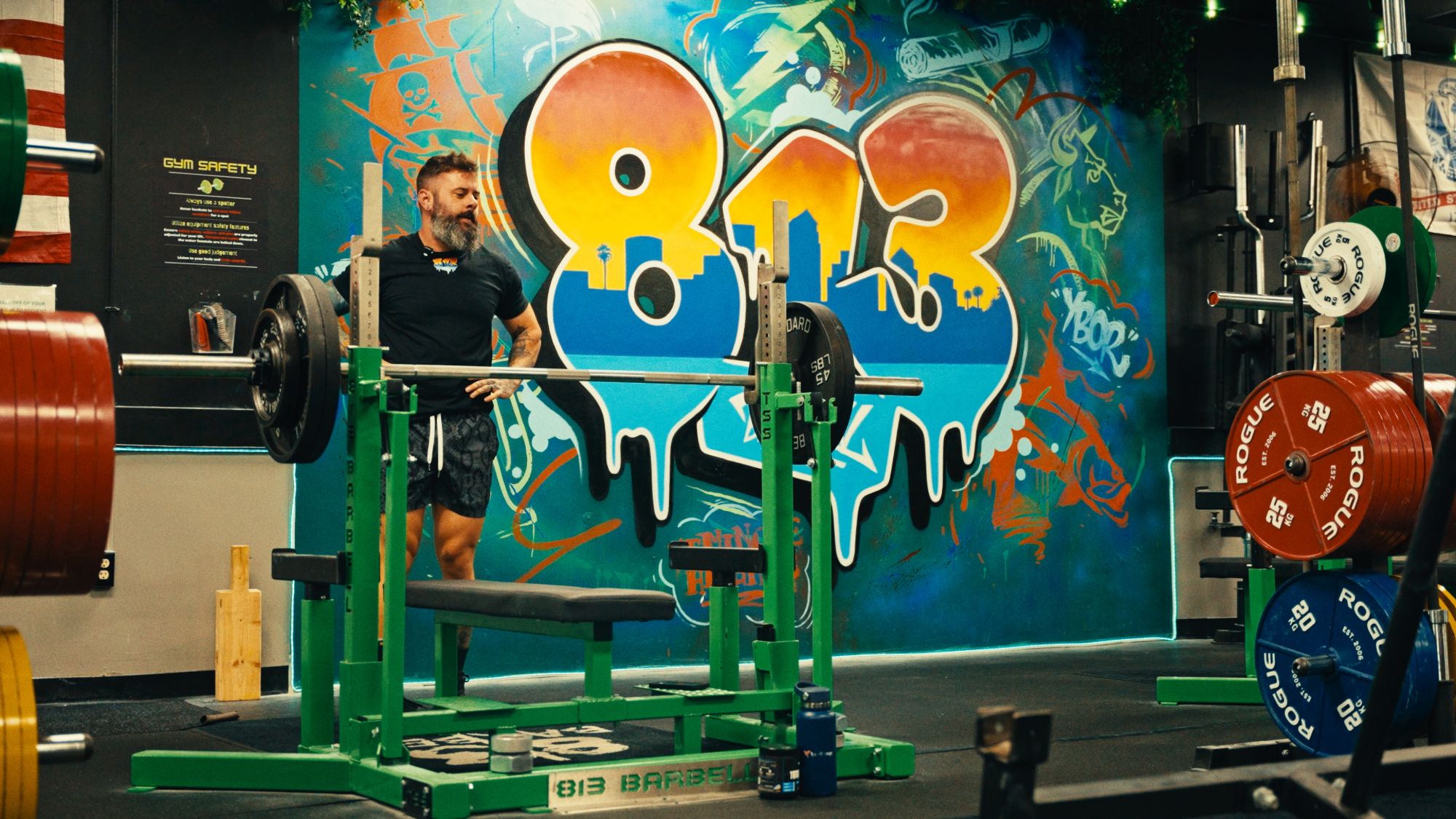 Thomas at the bench in front of the 813 mural at 813 Barbell